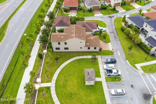an aerial view of a swimming pool with a yard