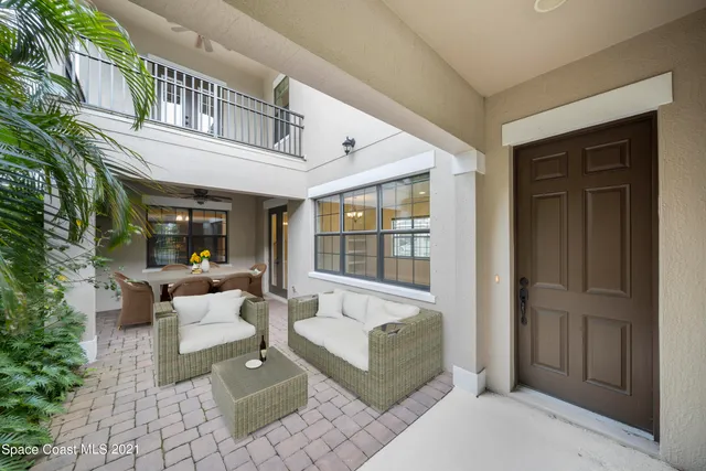 a balcony with furniture and a potted plant