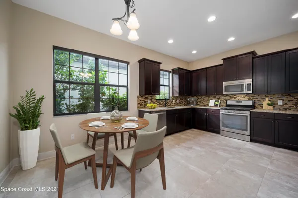 a kitchen with a table and chairs in it