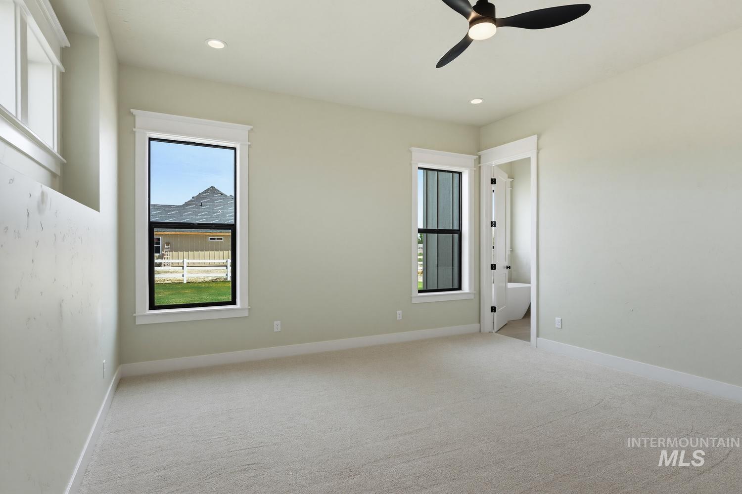 5054 Heritage Drive Marsing, ID 83639 - Photo 33 of 38 Neutral-toned carpeting and walls complement two tall windows with white trim