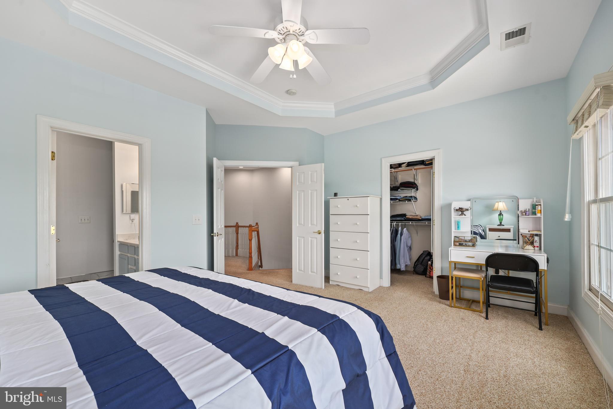 6806 Witton Circle Gainesville, VA 20155 - Photo 18 of 47 a bedroom with a bed and a chandelier