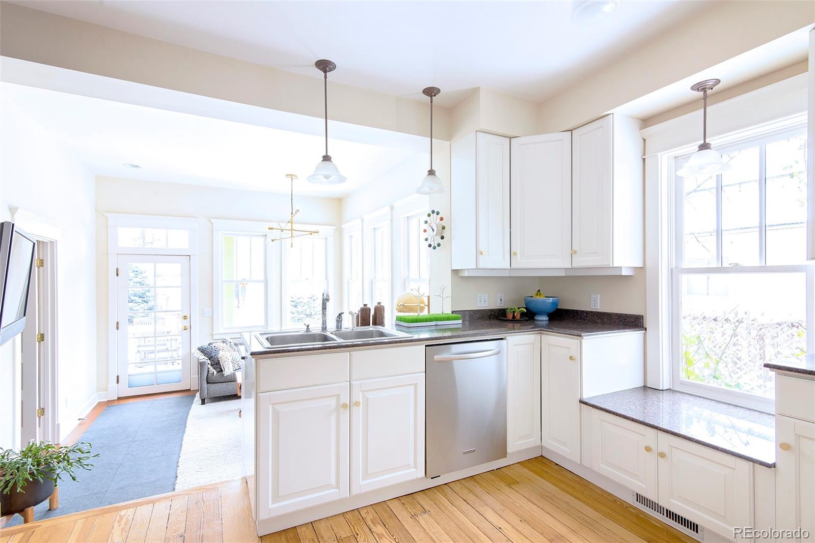 2137 Pine Street Boulder, CO 80302 - Photo 16 of 40 a kitchen with a sink stove and wooden cabinets
