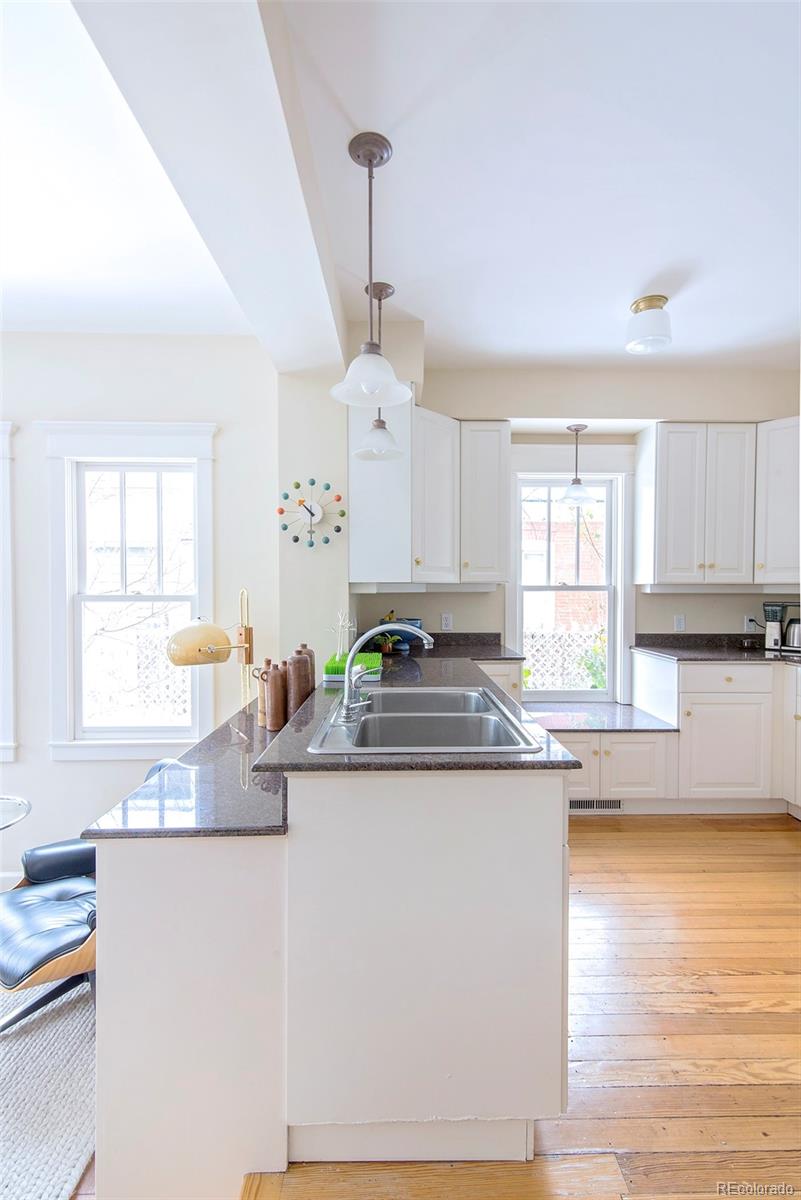 2137 Pine Street Boulder, CO 80302 - Photo 18 of 40 a kitchen with stainless steel appliances granite countertop a sink a stove and white cabinets