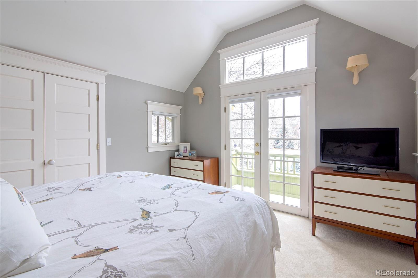 2137 Pine Street Boulder, CO 80302 - Photo 25 of 40 a bedroom with a bed and a flat screen tv