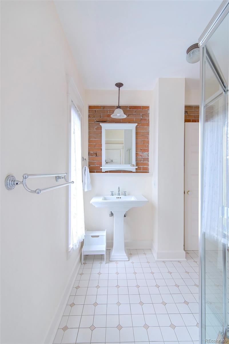 2137 Pine Street Boulder, CO 80302 - Photo 27 of 40 a bathroom with a sink a toilet and mirror