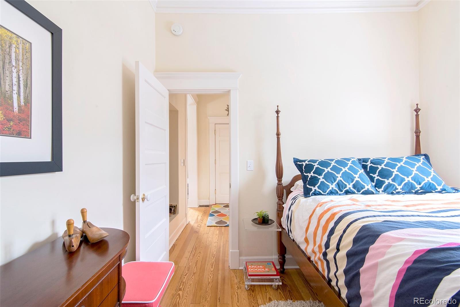2137 Pine Street Boulder, CO 80302 - Photo 37 of 40 a bedroom with a bed and wooden floor