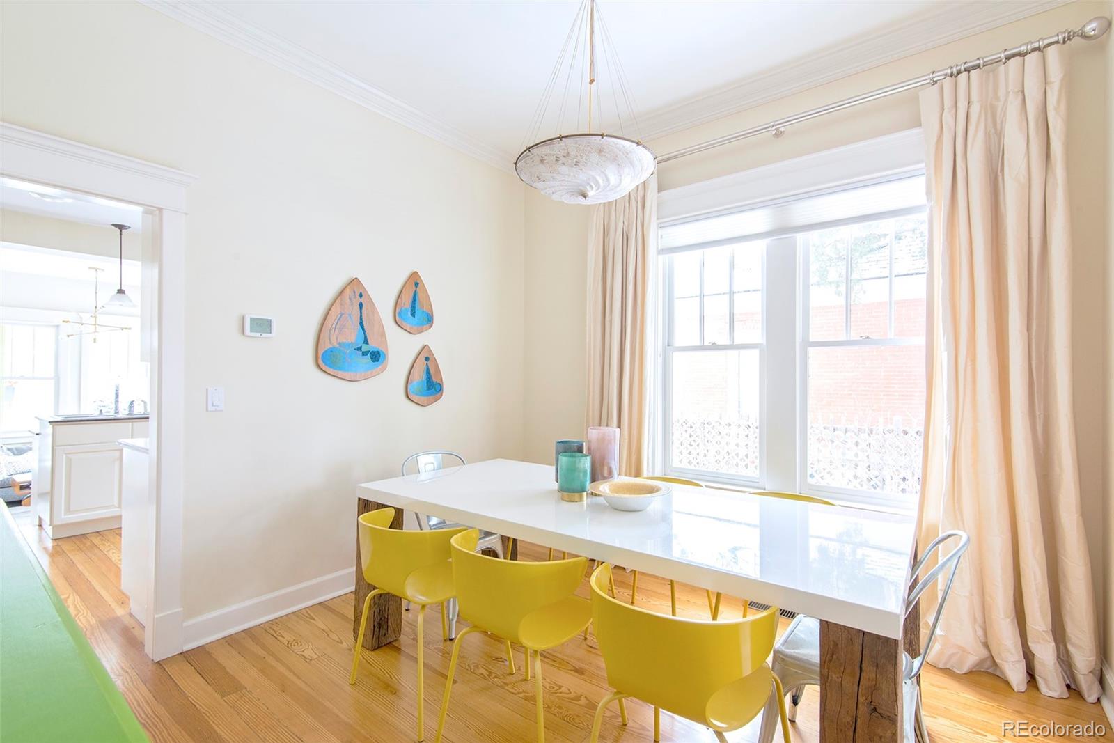 2137 Pine Street Boulder, CO 80302 - Photo 9 of 40 a view of a dining room with furniture a chandelier and wooden floor
