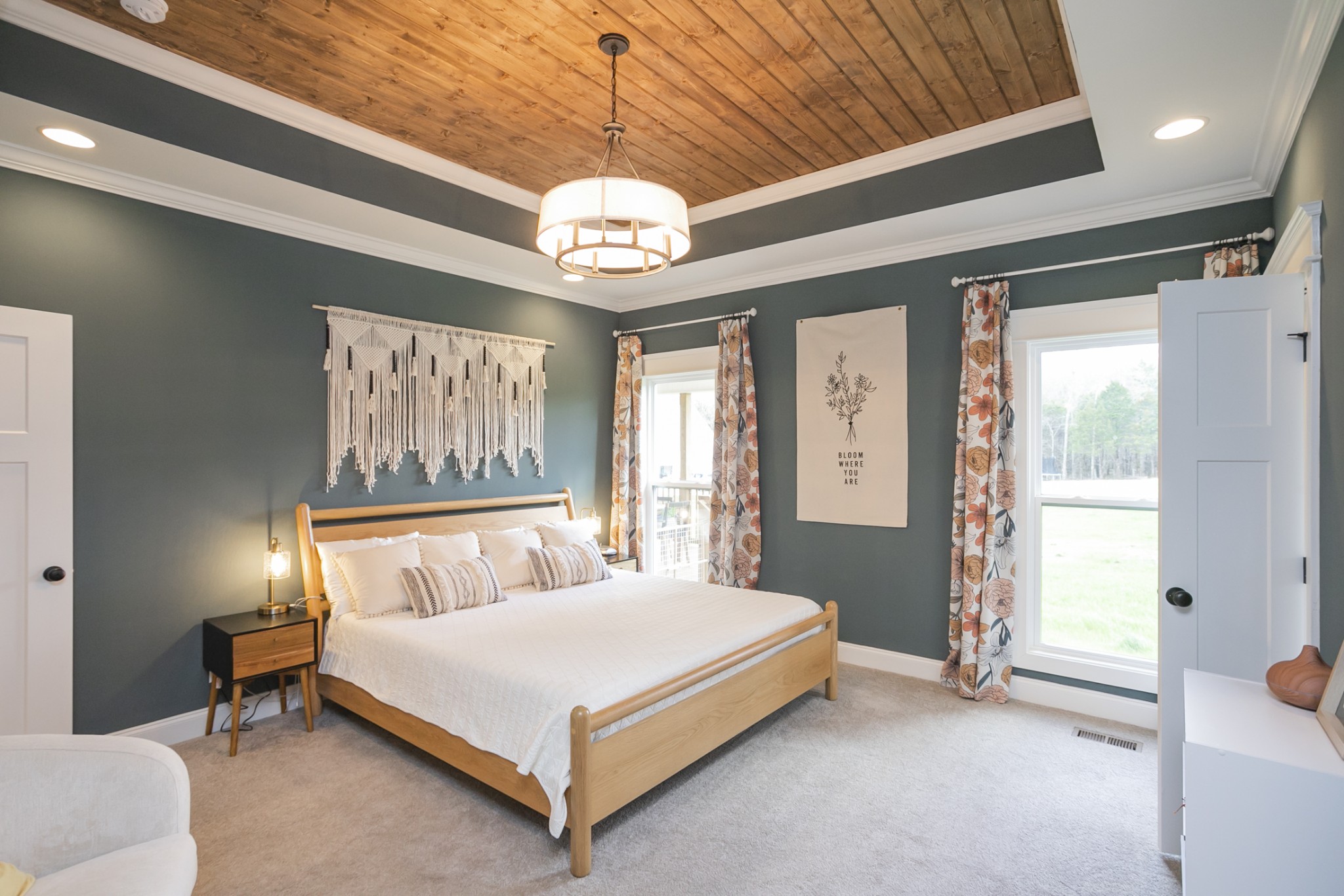6599 Simmons Bluff Road Lebanon, TN 37090 - Photo 9 of 23 a bedroom with a large bed and a chandelier