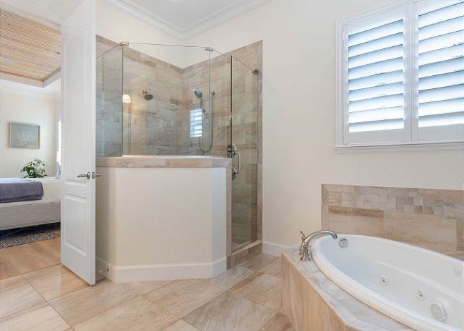 503 Cinnamon Beach Lane Palm Coast, FL 32137 - Photo 14 of 50 a bathroom with a bathtub and a shower