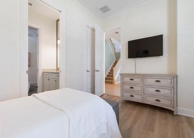 a bedroom with a bed and a flat screen tv