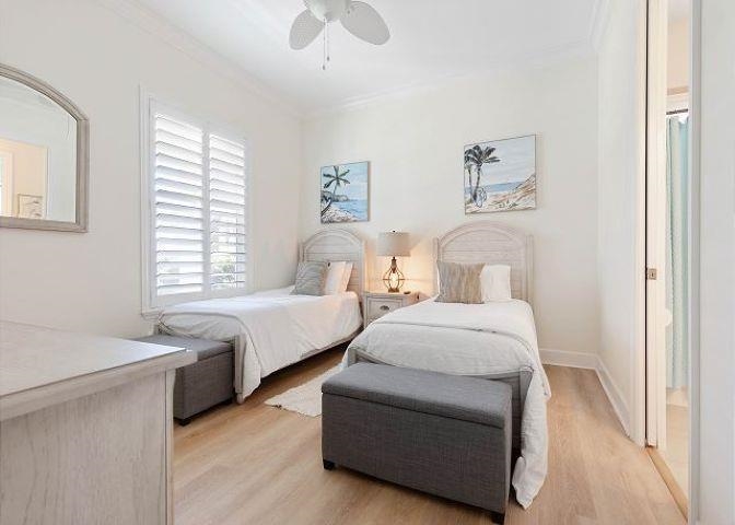 503 Cinnamon Beach Lane Palm Coast, FL 32137 - Photo 21 of 50 a spacious bedroom with two beds and a chandelier