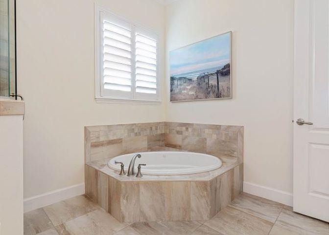 503 Cinnamon Beach Lane Palm Coast, FL 32137 - Photo 24 of 50 a bathroom with a tub and window