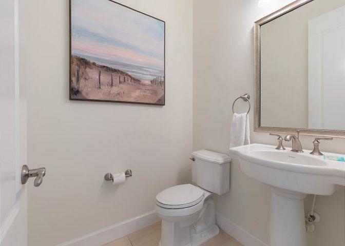 503 Cinnamon Beach Lane Palm Coast, FL 32137 - Photo 25 of 50 a bathroom with a toilet sink and mirror
