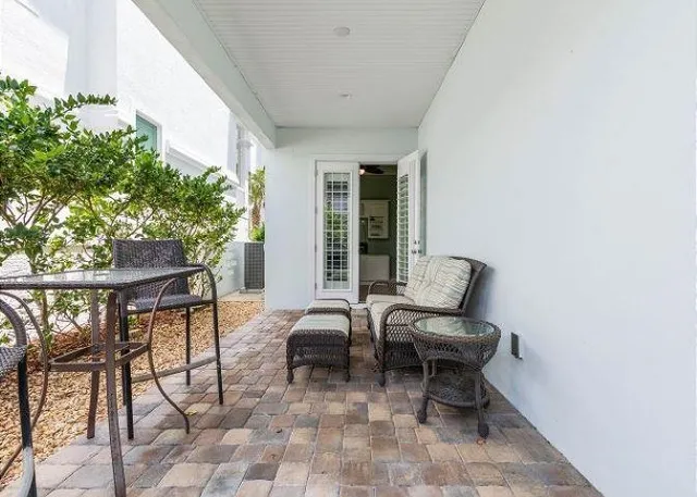 a view of a patio with couple of chairs