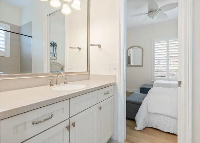 a en suite bathroom with a double vanity sink and a mirror