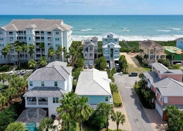 an aerial view of multiple houses with yard
