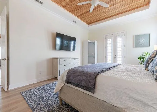 a bedroom with a bed and a flat screen tv