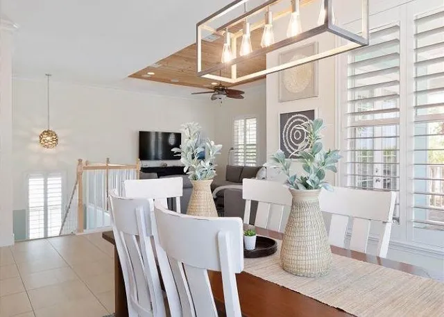 a living room with furniture a flat screen tv and a window