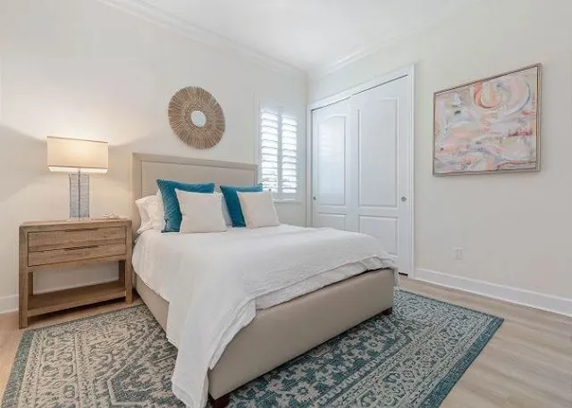 a bedroom with a bed and a painting on the wall