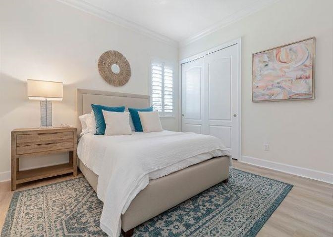 503 Cinnamon Beach Lane Palm Coast, FL 32137 - Photo 43 of 50 a bedroom with a bed and a painting on the wall