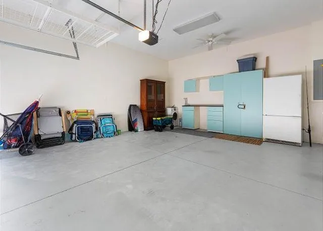 an aerial view of ocean and residential houses with outdoor space