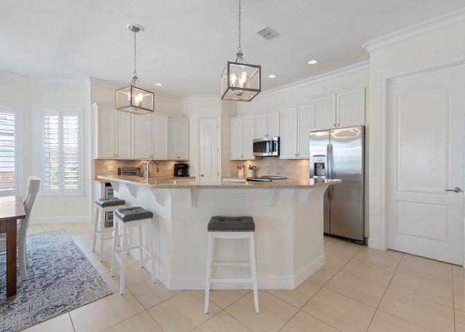 503 Cinnamon Beach Lane Palm Coast, FL 32137 - Photo 7 of 50 a kitchen with kitchen island granite countertop a counter space a sink appliances and cabinets