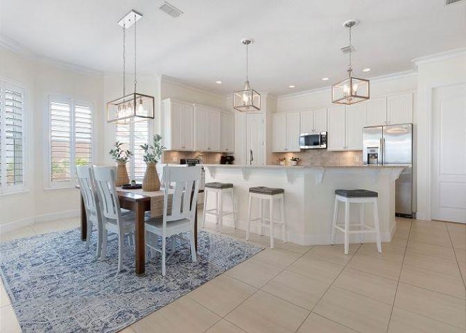 503 Cinnamon Beach Lane Palm Coast, FL 32137 - Photo 10 of 50 a large kitchen with a table and chairs