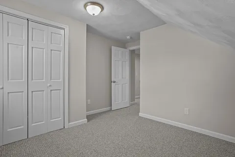an empty room with fan and windows