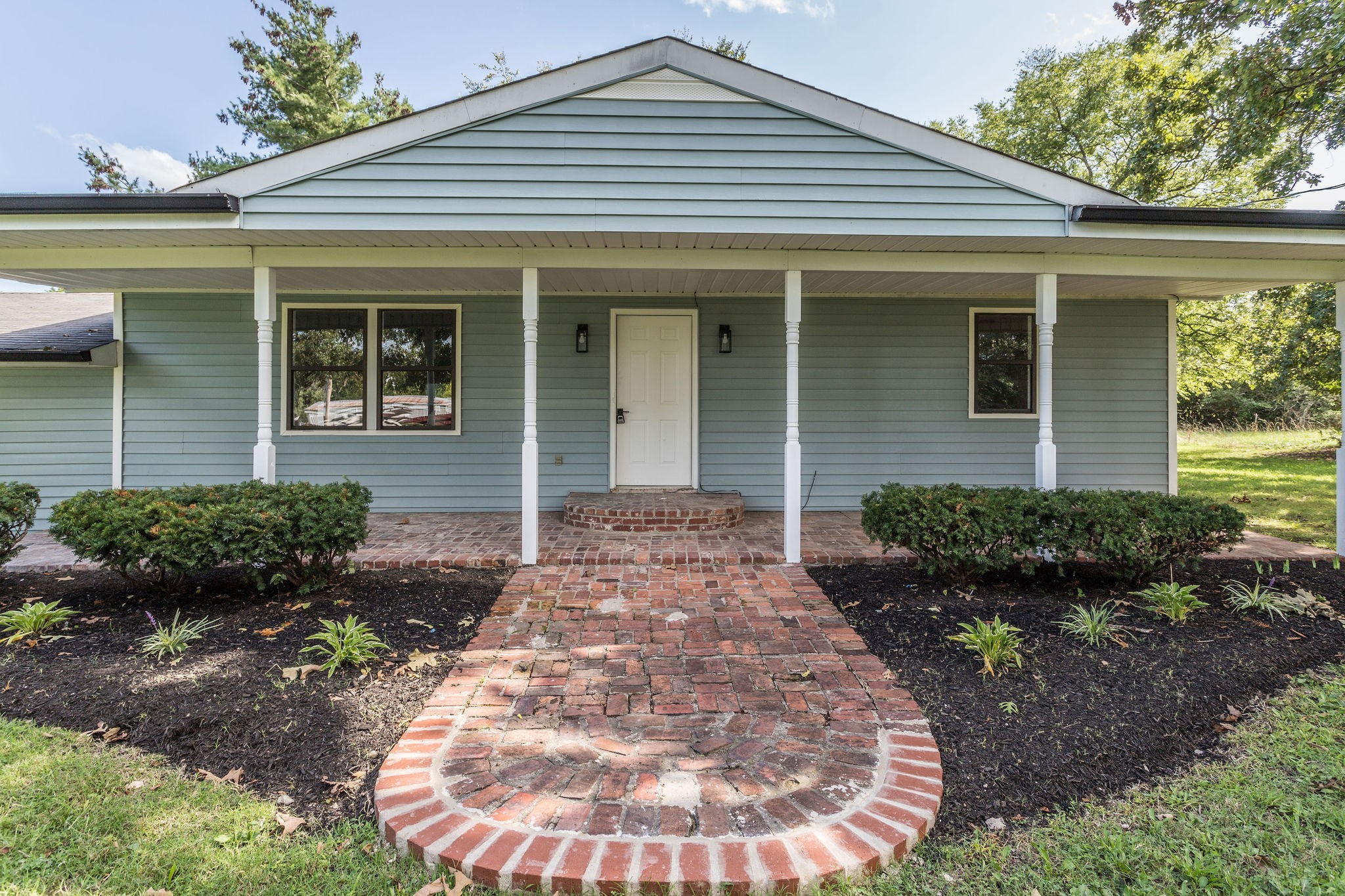 a front view of a house with garden