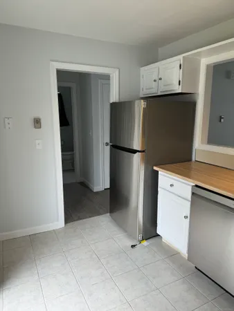 a kitchen with a refrigerator and a stove