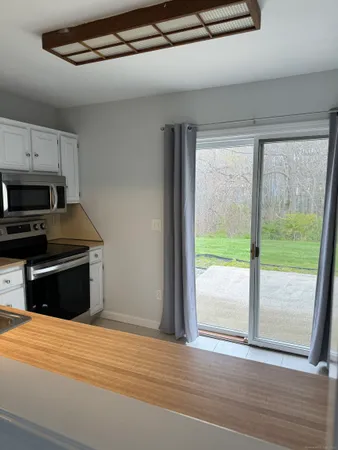 a kitchen with a stove a refrigerator and a sink