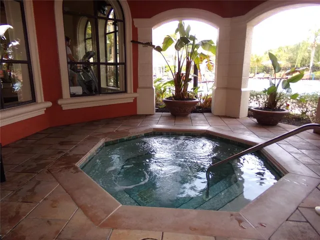 a living room with furniture a flat screen tv and paintings on the wall