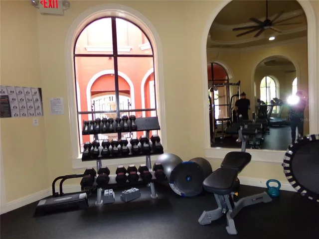 a dining room with furniture and a mirror