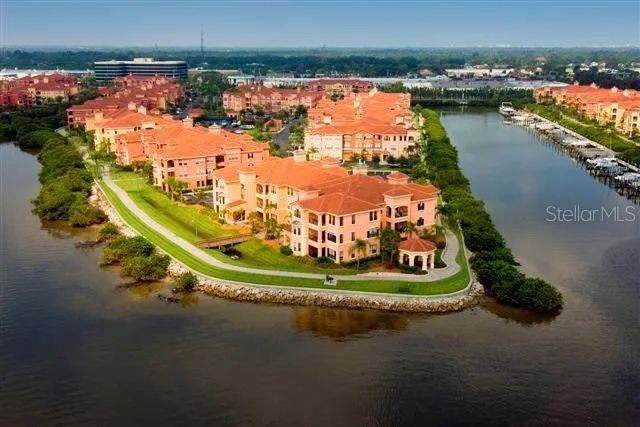an aerial view of a house with a garden and lake view