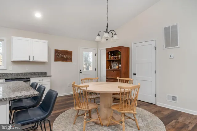 a spacious bedroom with a bed a window and couch