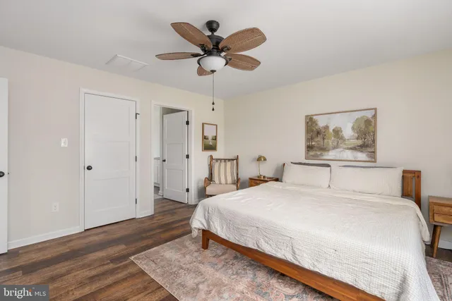 a bedroom with a bed and a painting on the wall