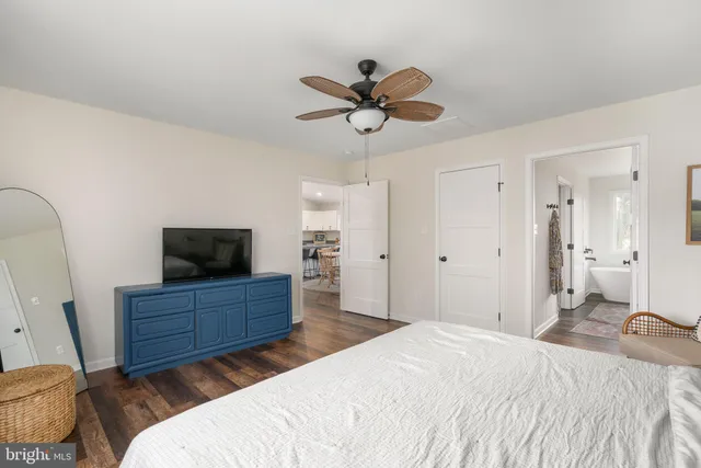 a bathroom with a granite countertop sink and a bathtub