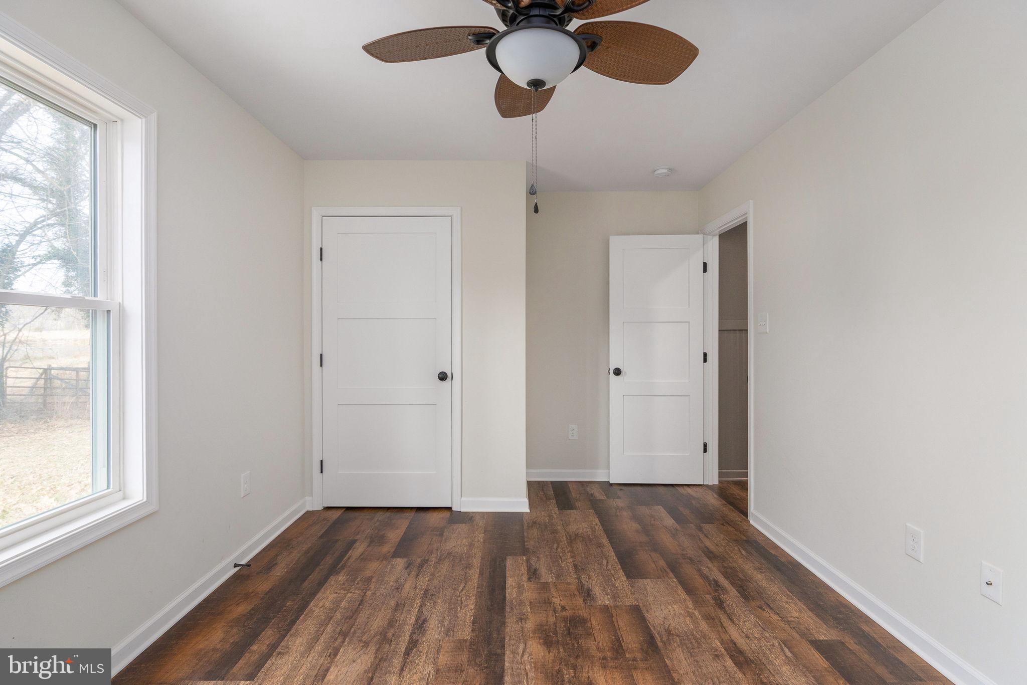 158 Red Hill Road Orange, VA 22960 - Photo 38 of 54 a view of empty room with wooden floor and fan