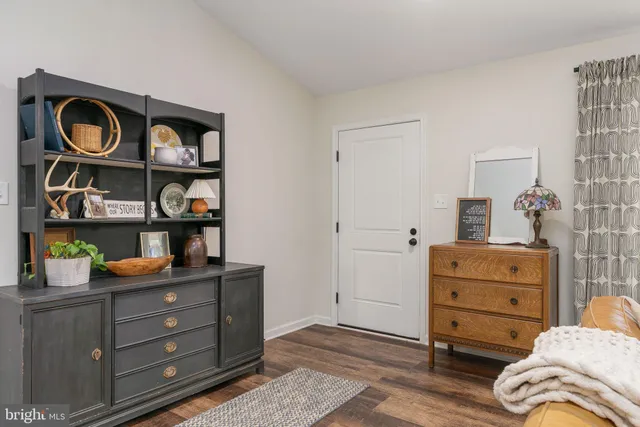 a room with a dresser and book shelf