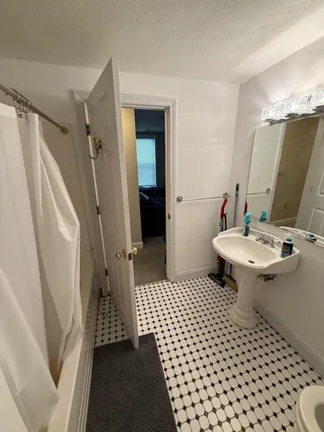 a kitchen with a refrigerator a stove top oven a sink dishwasher and white cabinets with wooden floor