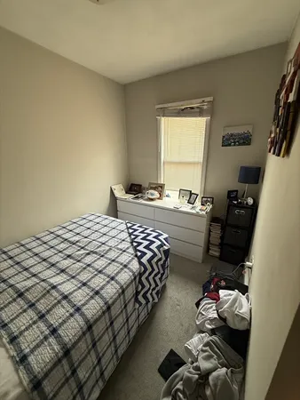 a bedroom with bed and a window