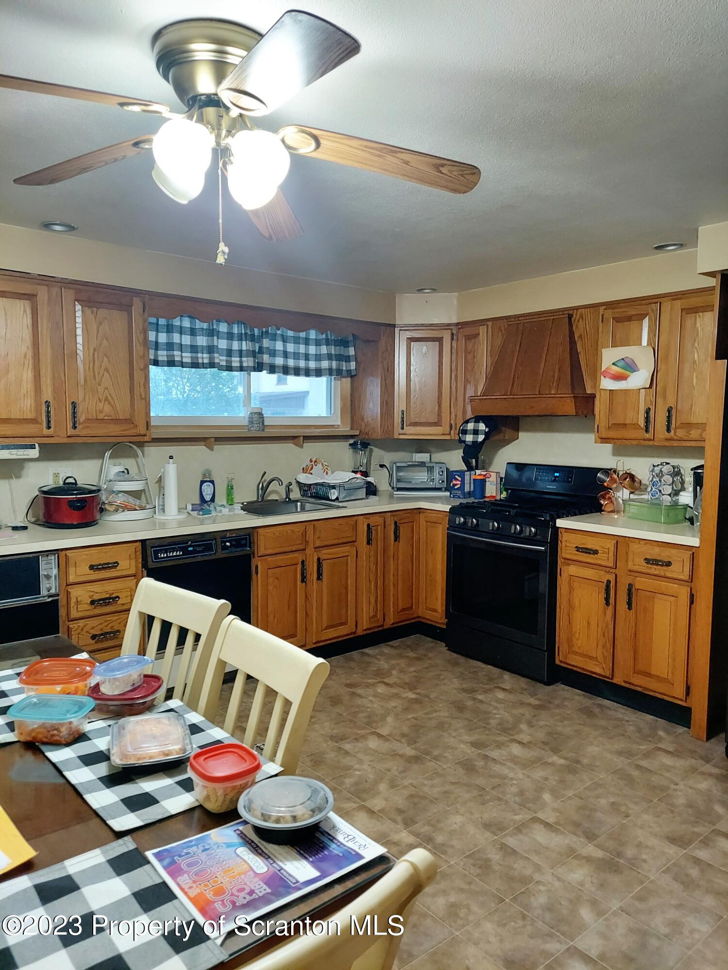 214 Cherry Street Dunmore, PA 18512 - Photo 11 of 58 a kitchen with a stove cabinets and window