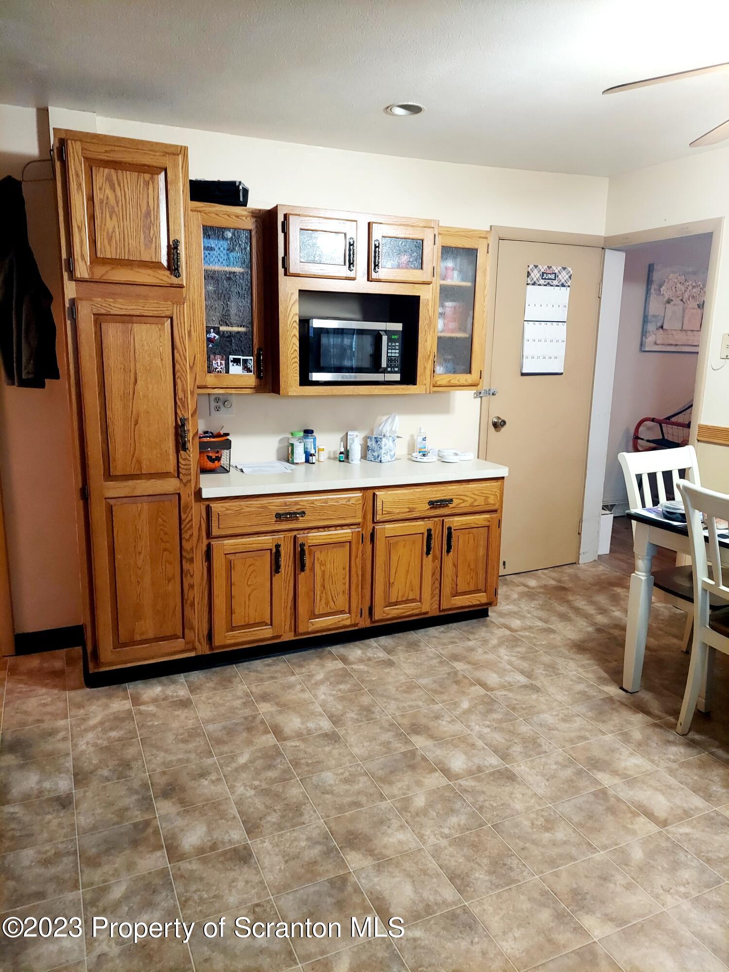 214 Cherry Street Dunmore, PA 18512 - Photo 14 of 58 a large kitchen with stainless steel appliances a sink and a refrigerator