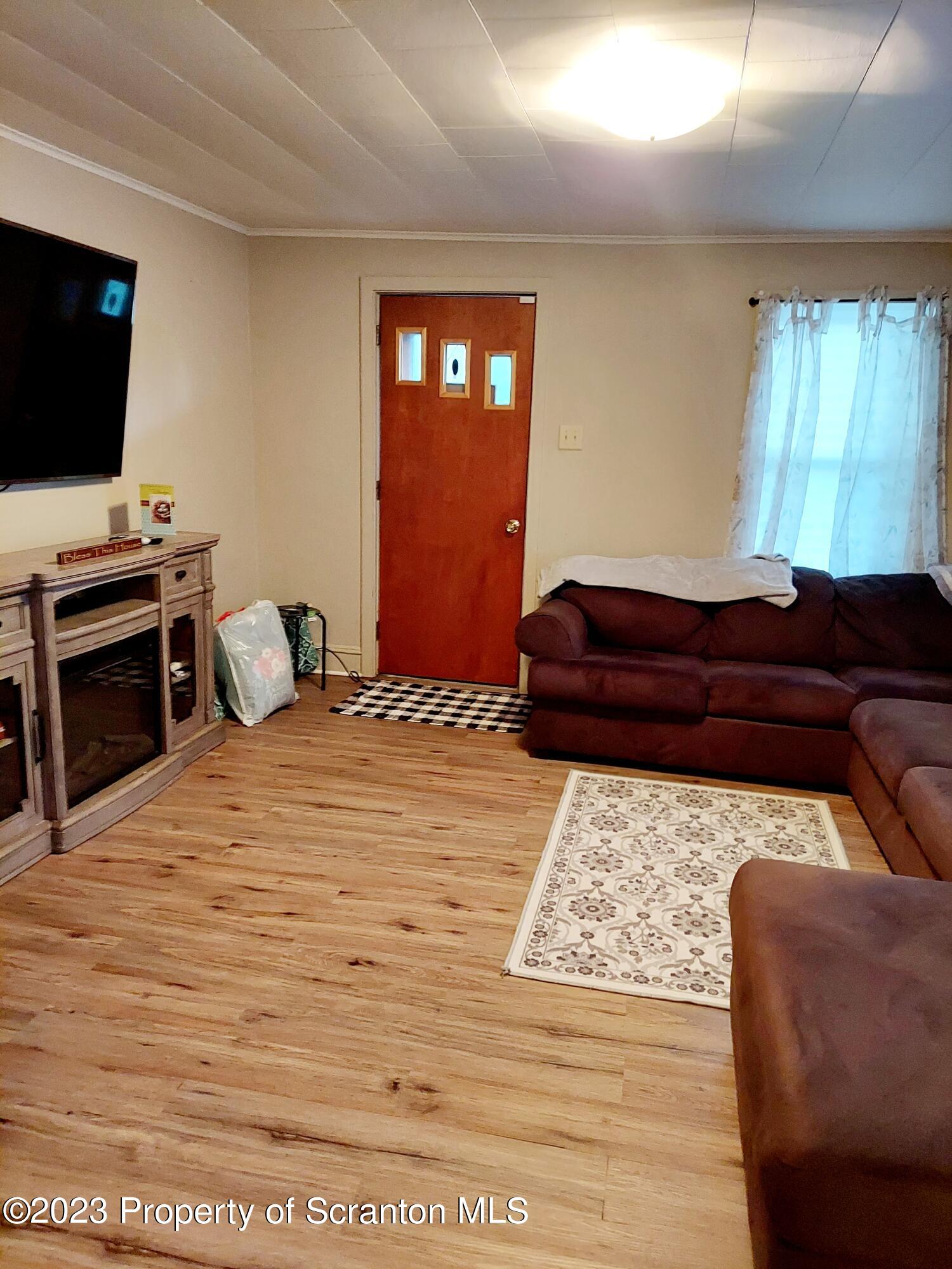 214 Cherry Street Dunmore, PA 18512 - Photo 19 of 58 a living room with a couch and a flat screen tv