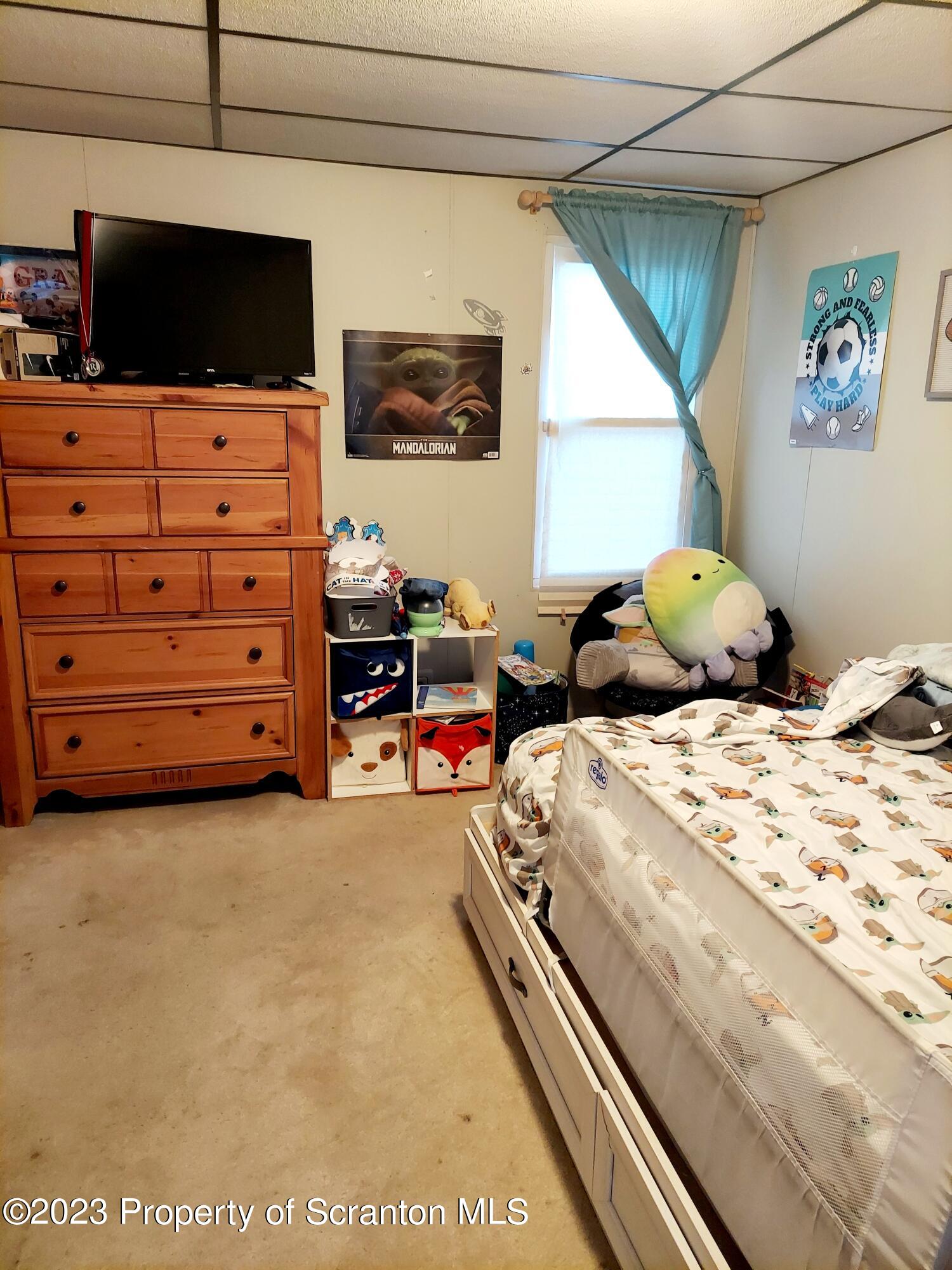 214 Cherry Street Dunmore, PA 18512 - Photo 25 of 58 a bedroom with a bed a flat screen tv and dresser