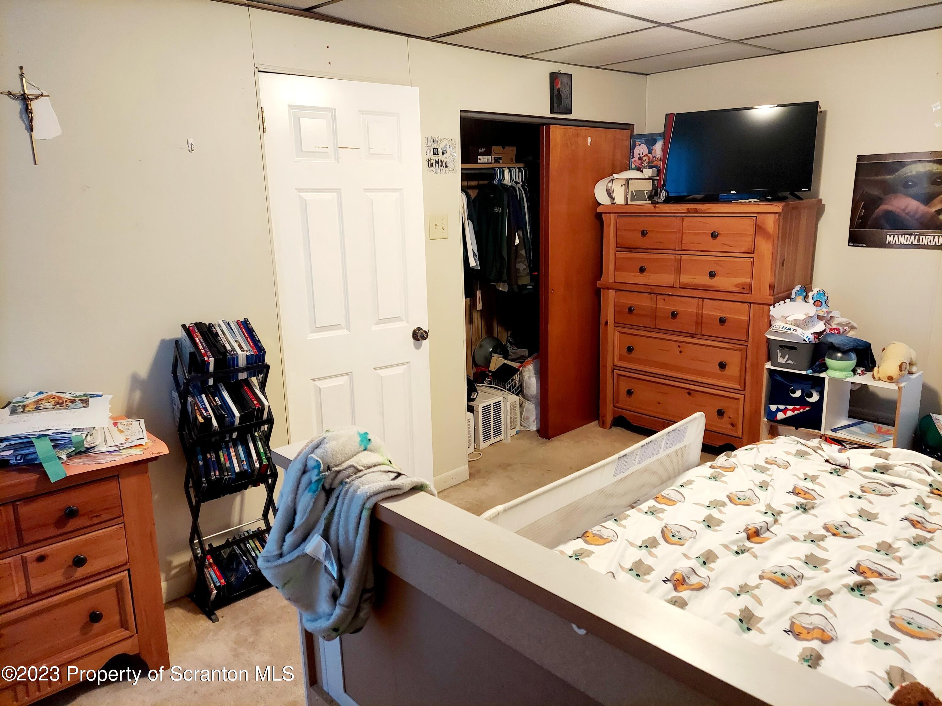 214 Cherry Street Dunmore, PA 18512 - Photo 26 of 58 a bed room with a bed and a television