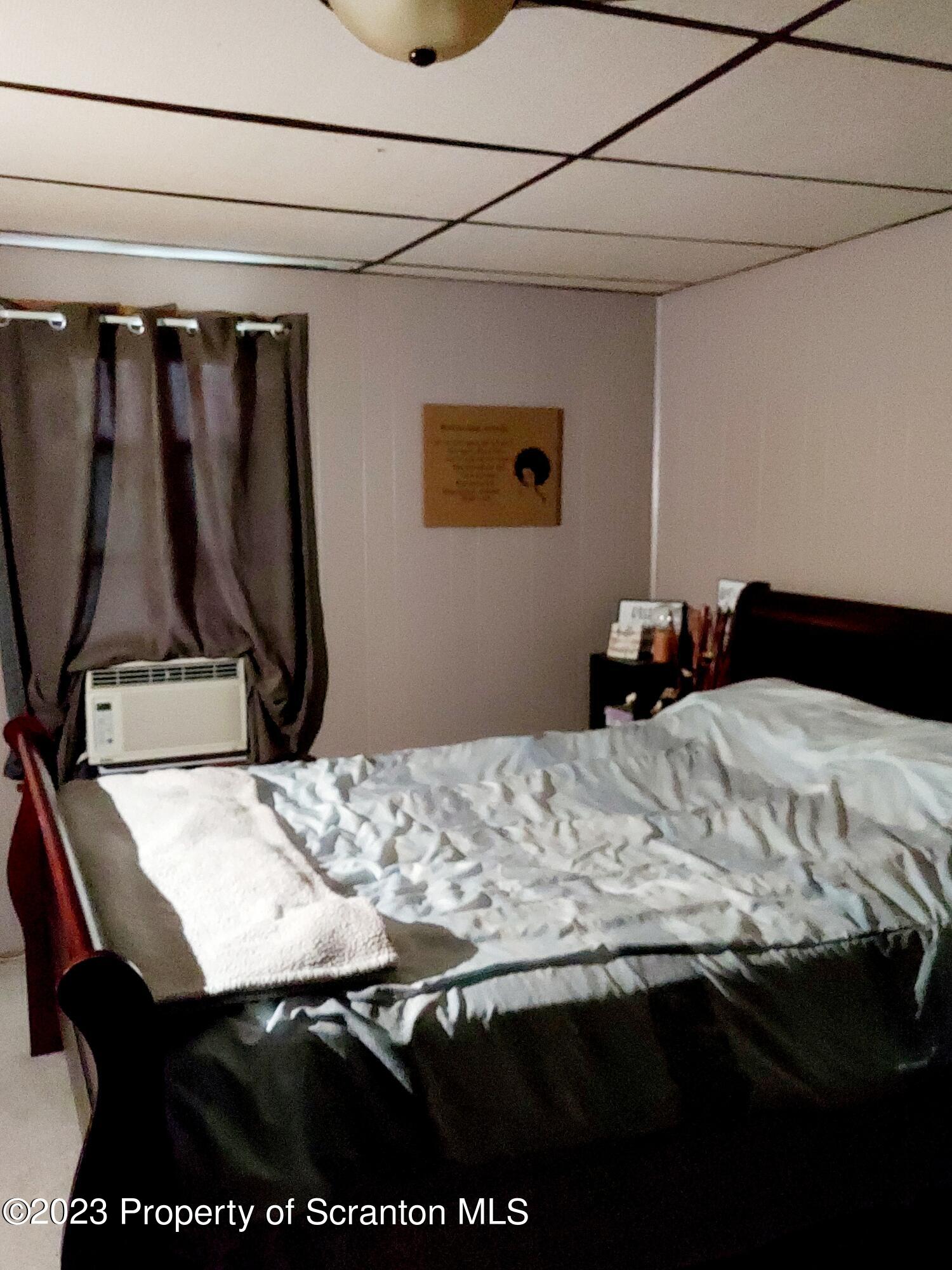 214 Cherry Street Dunmore, PA 18512 - Photo 30 of 58 a bedroom with a bed and a dresser