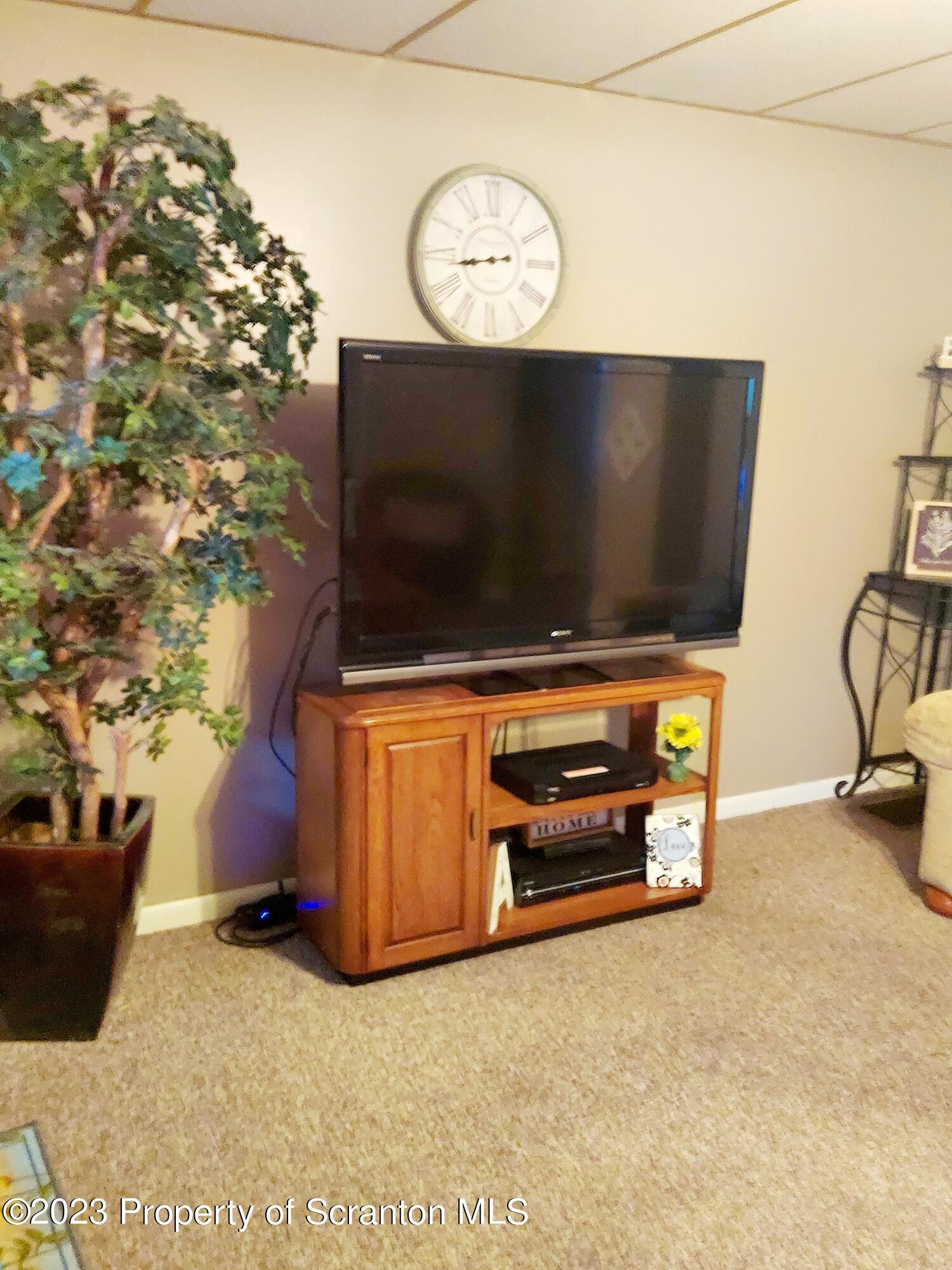 214 Cherry Street Dunmore, PA 18512 - Photo 32 of 58 a living room with furniture and a flat screen tv