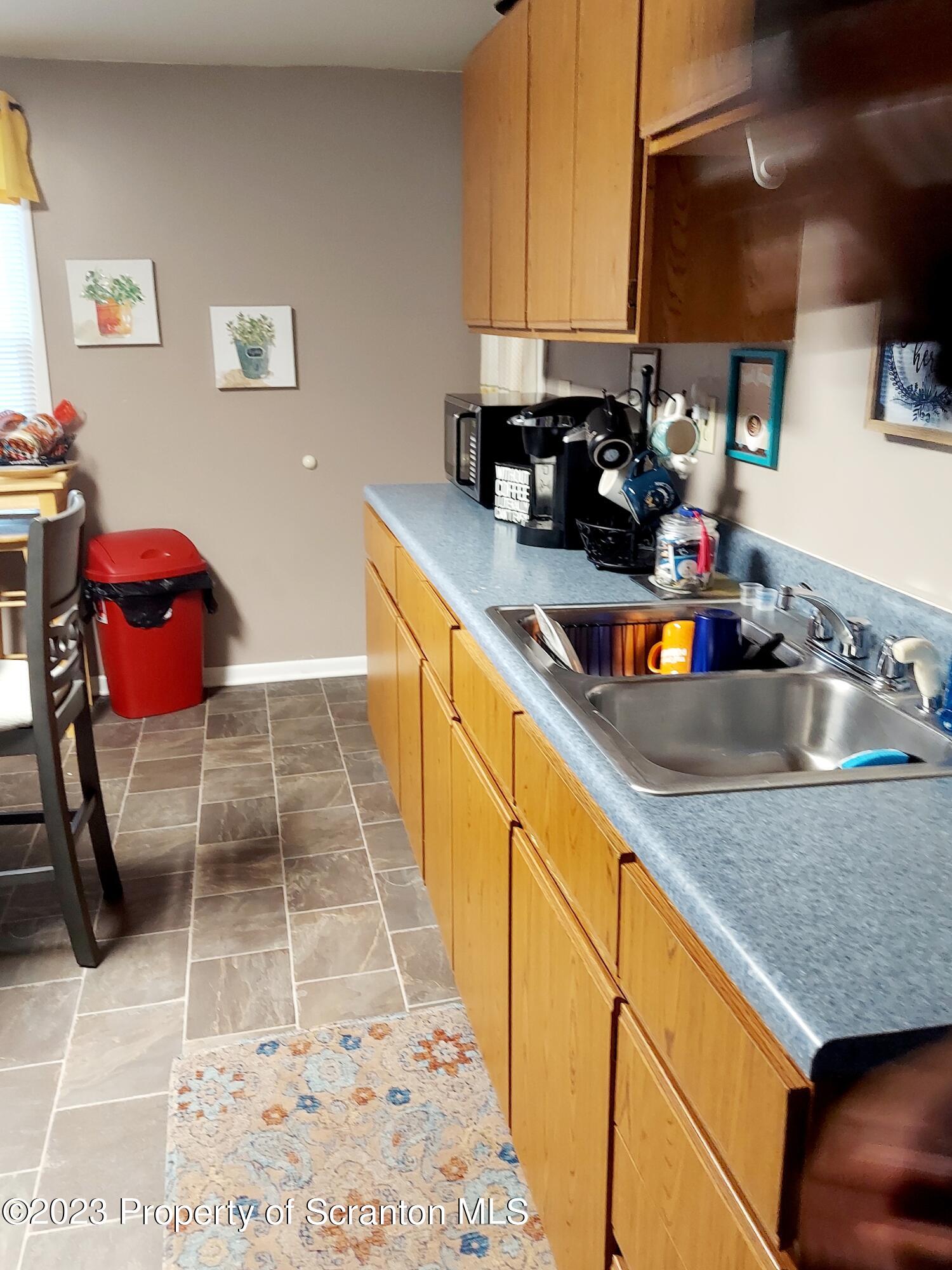 214 Cherry Street Dunmore, PA 18512 - Photo 36 of 58 a kitchen with granite countertop a sink a stove and cabinets