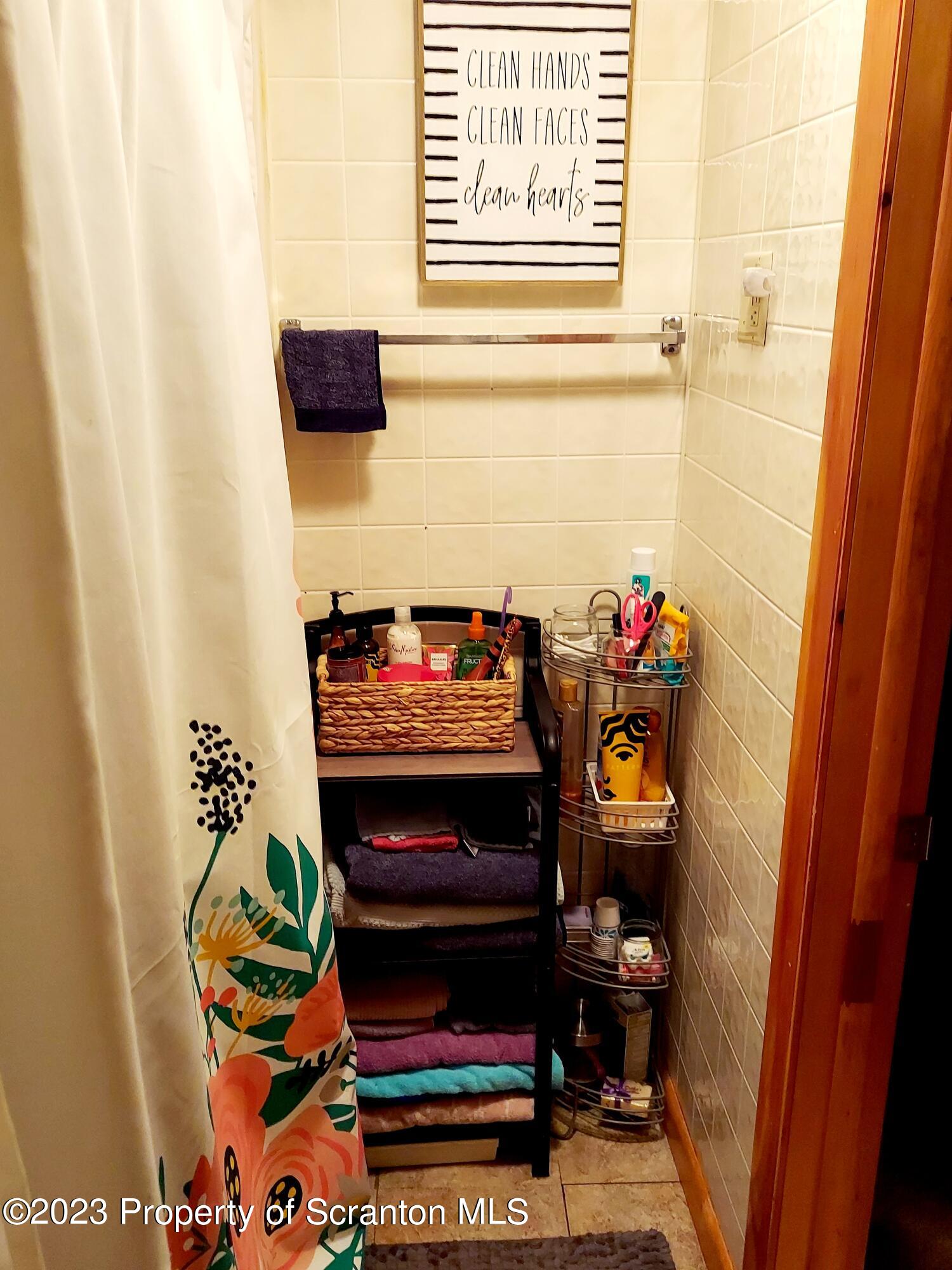 214 Cherry Street Dunmore, PA 18512 - Photo 45 of 58 a bathroom with a toilet and a shower curtain